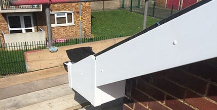 image of new white guttering with scaffolding in the image